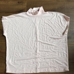 Pink turtle neck T-shirt.